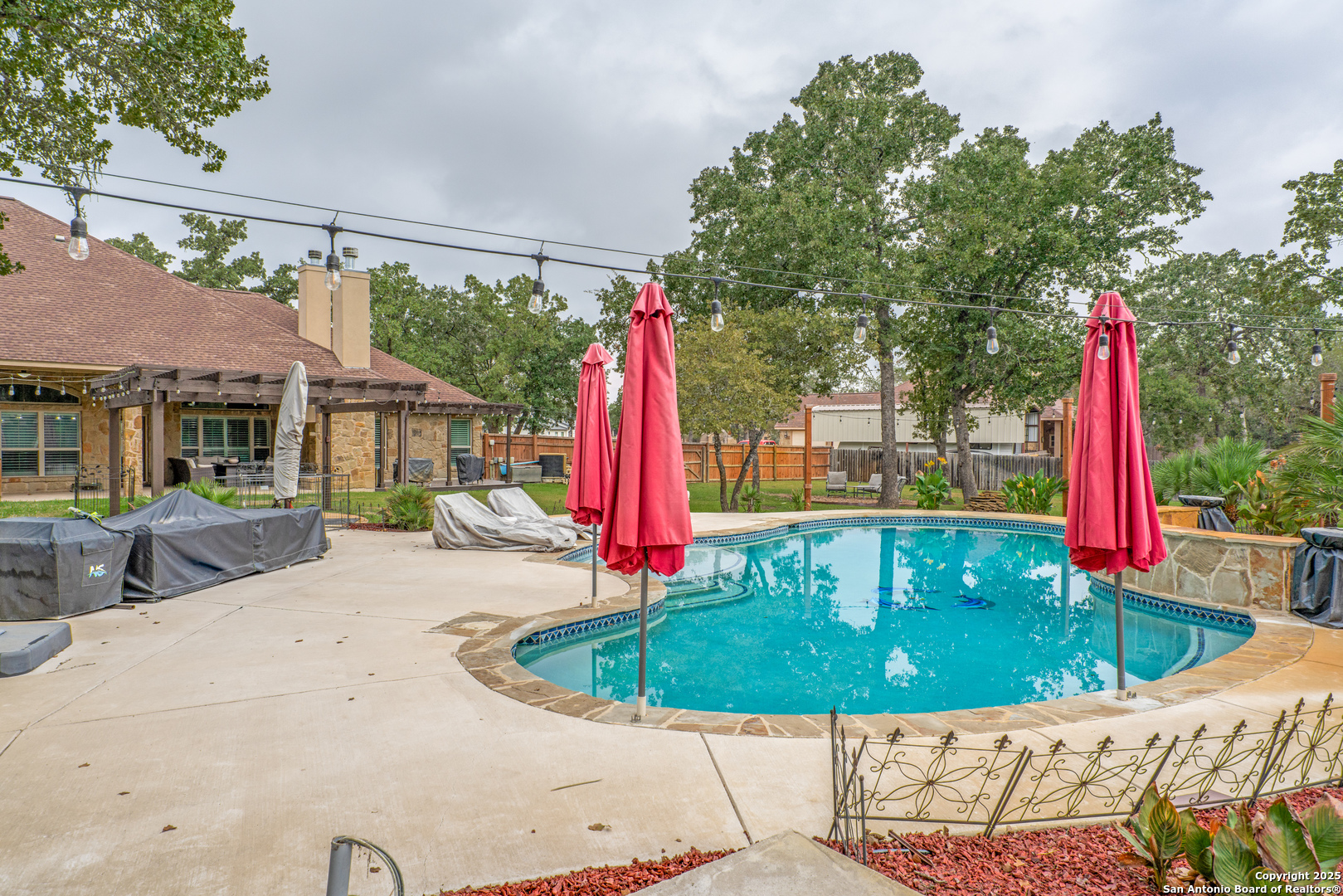 109 Bobcat Bend La Vernia, TX 78121 - Photo 32 of 36 a view of a house with a backyard and a small yard