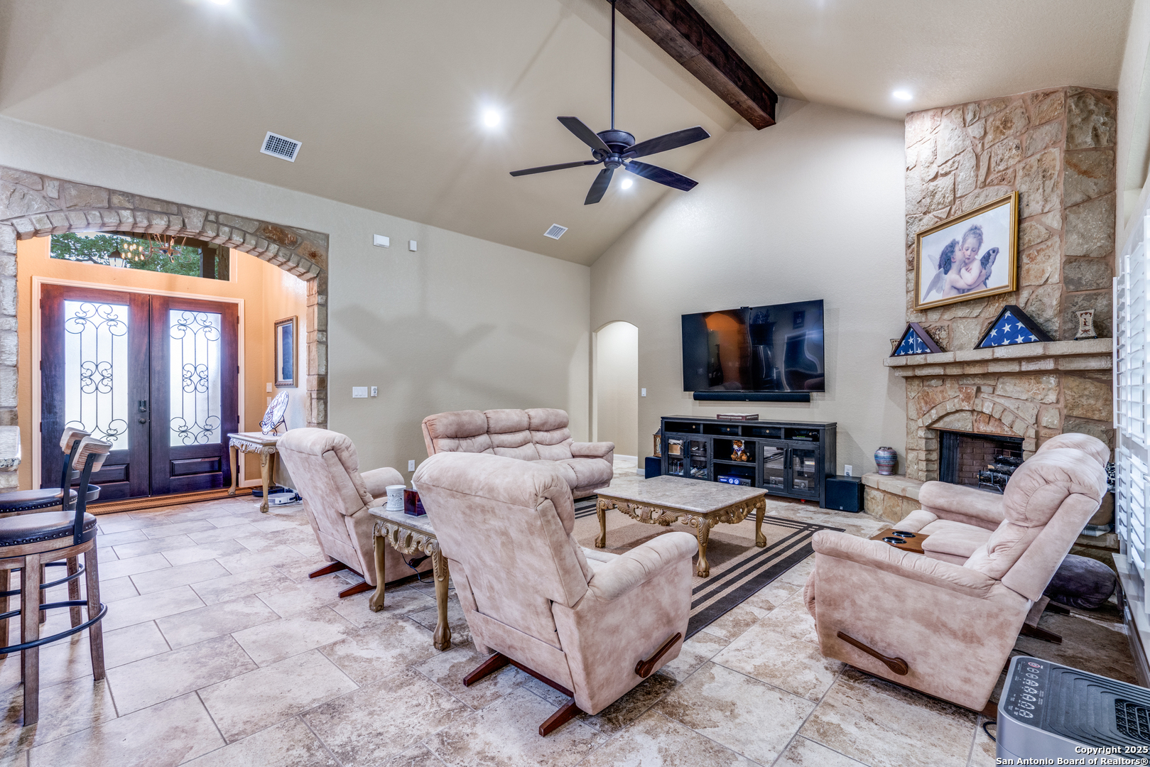 109 Bobcat Bend La Vernia, TX 78121 - Photo 4 of 36 a living room with furniture a large window and a flat screen tv