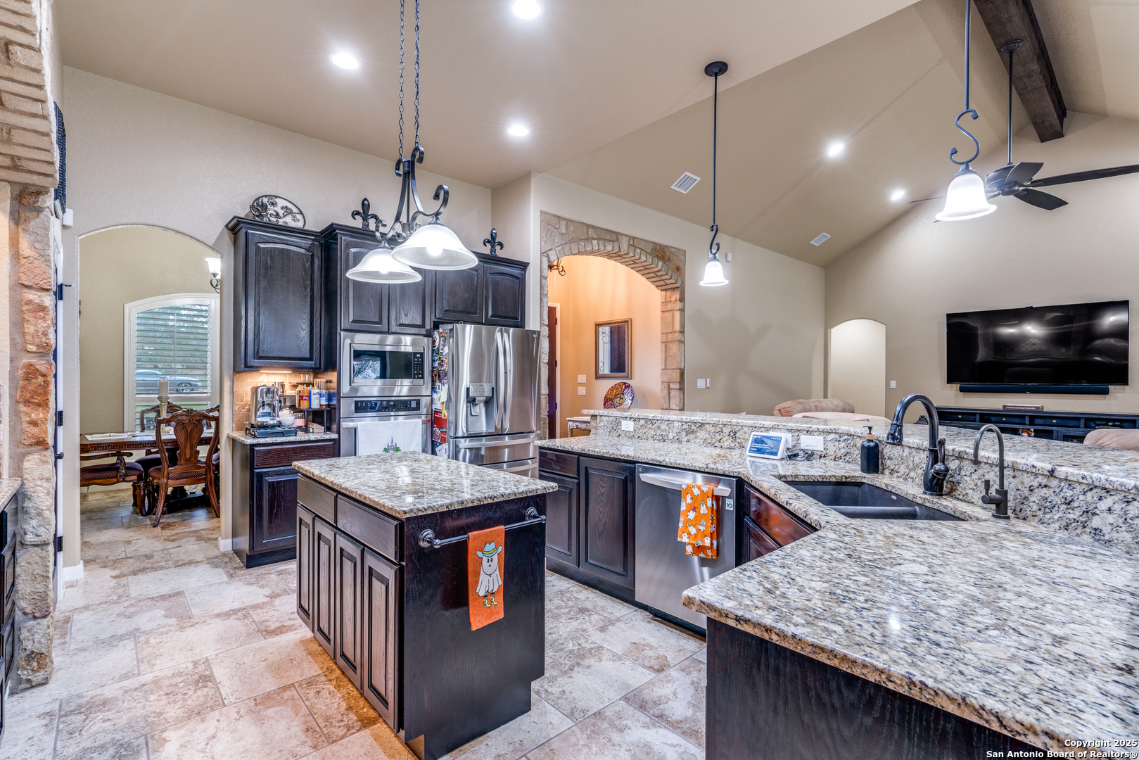 109 Bobcat Bend La Vernia, TX 78121 - Photo 8 of 36 a large kitchen with kitchen island a stove a sink dishwasher and a flat screen tv