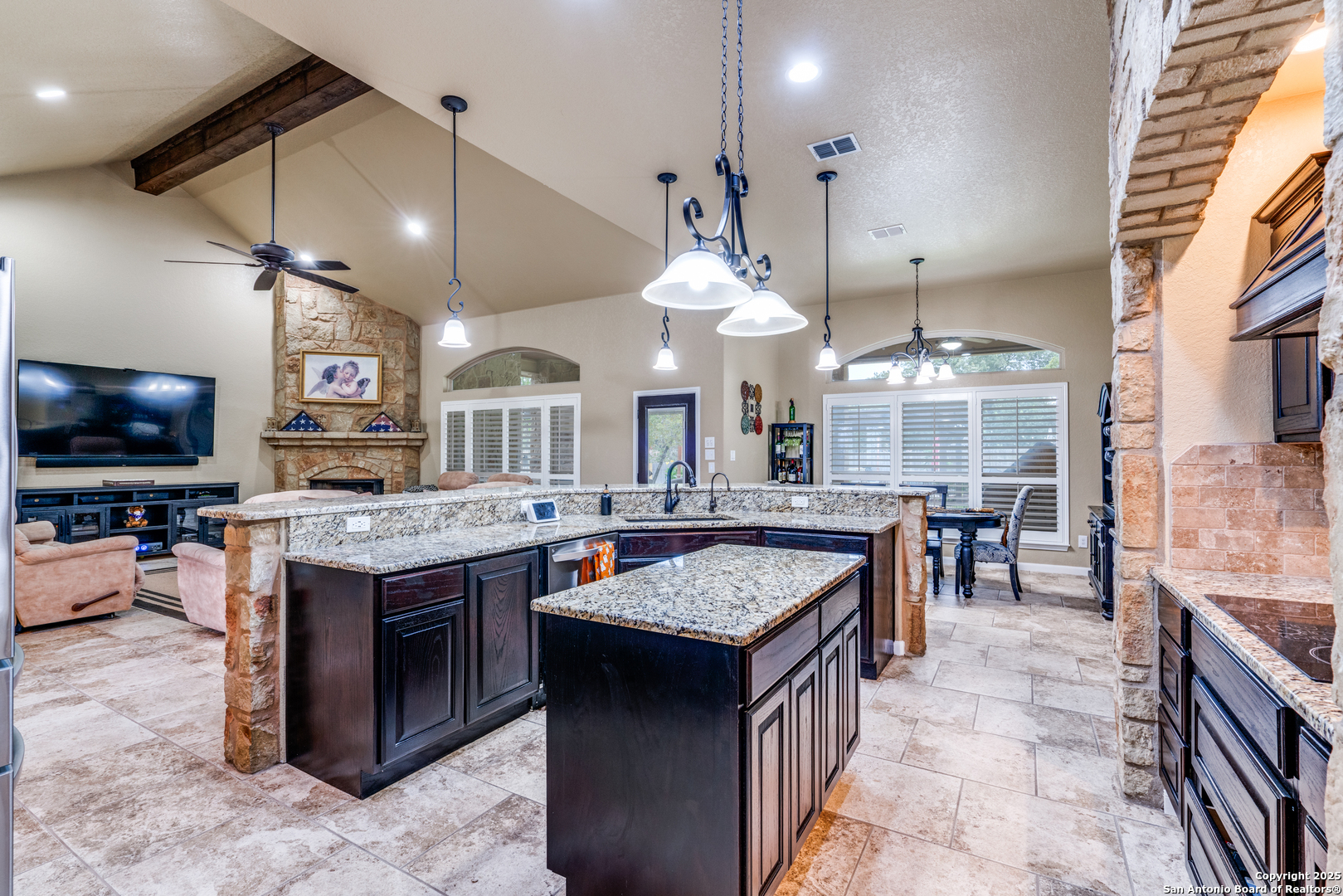 109 Bobcat Bend La Vernia, TX 78121 - Photo 9 of 36 a kitchen with a stove a counter top space a large cabinets and chairs