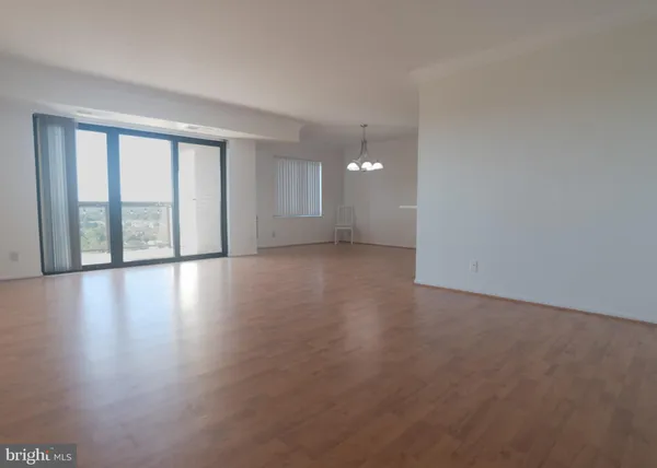 a large kitchen with cabinets stove top oven and stainless steel appliances