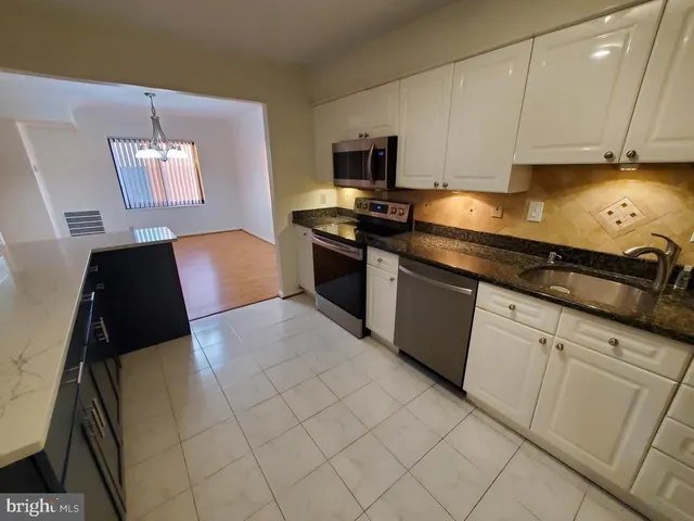 a kitchen with a sink and wooden cabinets