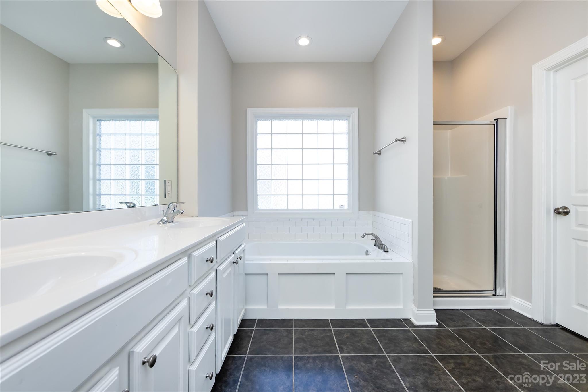 18909 Ruffner Drive Cornelius, NC 28031 - Photo 11 of 22 a bathroom with a tub sink and a window