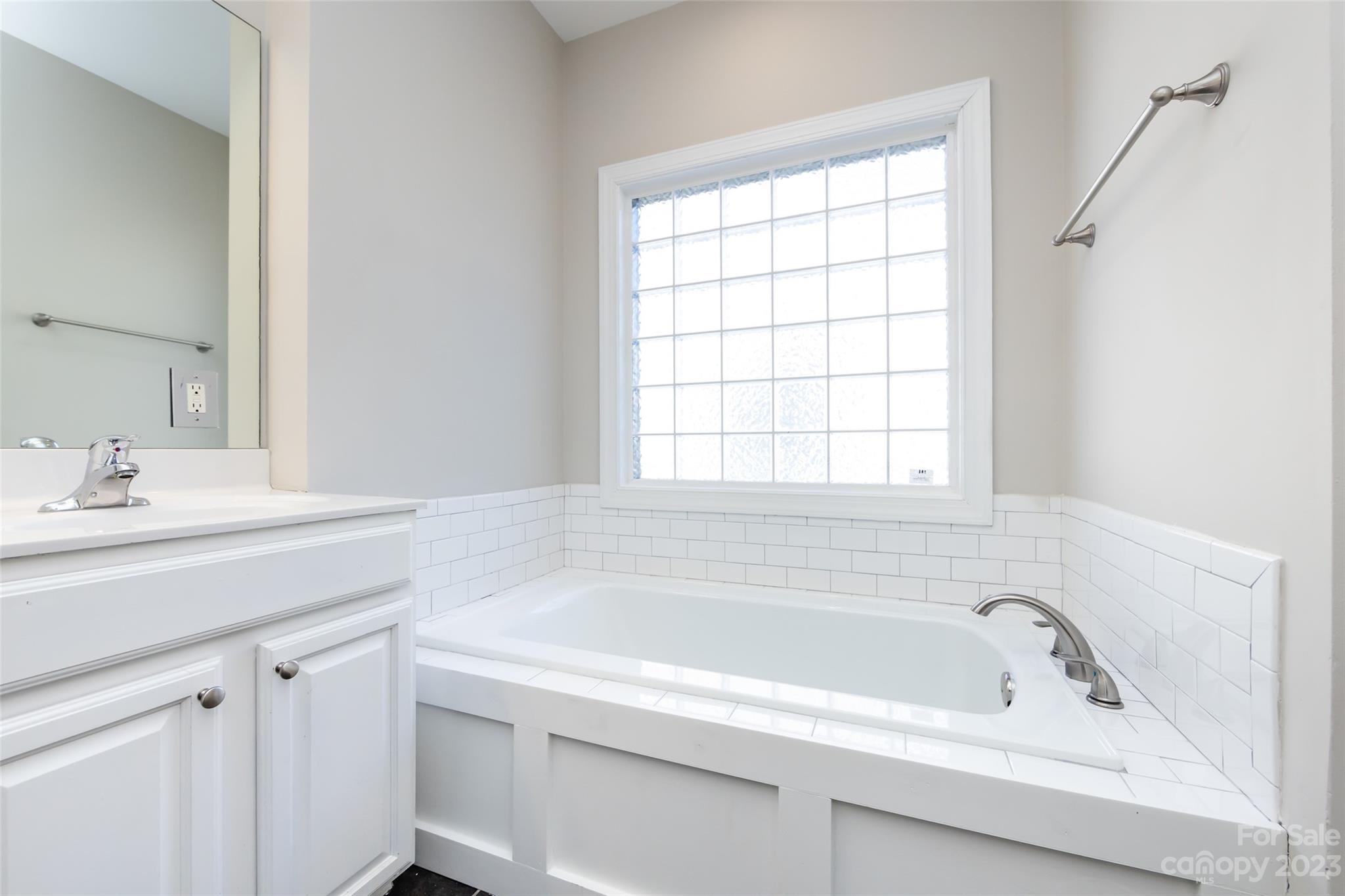 18909 Ruffner Drive Cornelius, NC 28031 - Photo 12 of 22 a white bath tub sitting next to a white sink