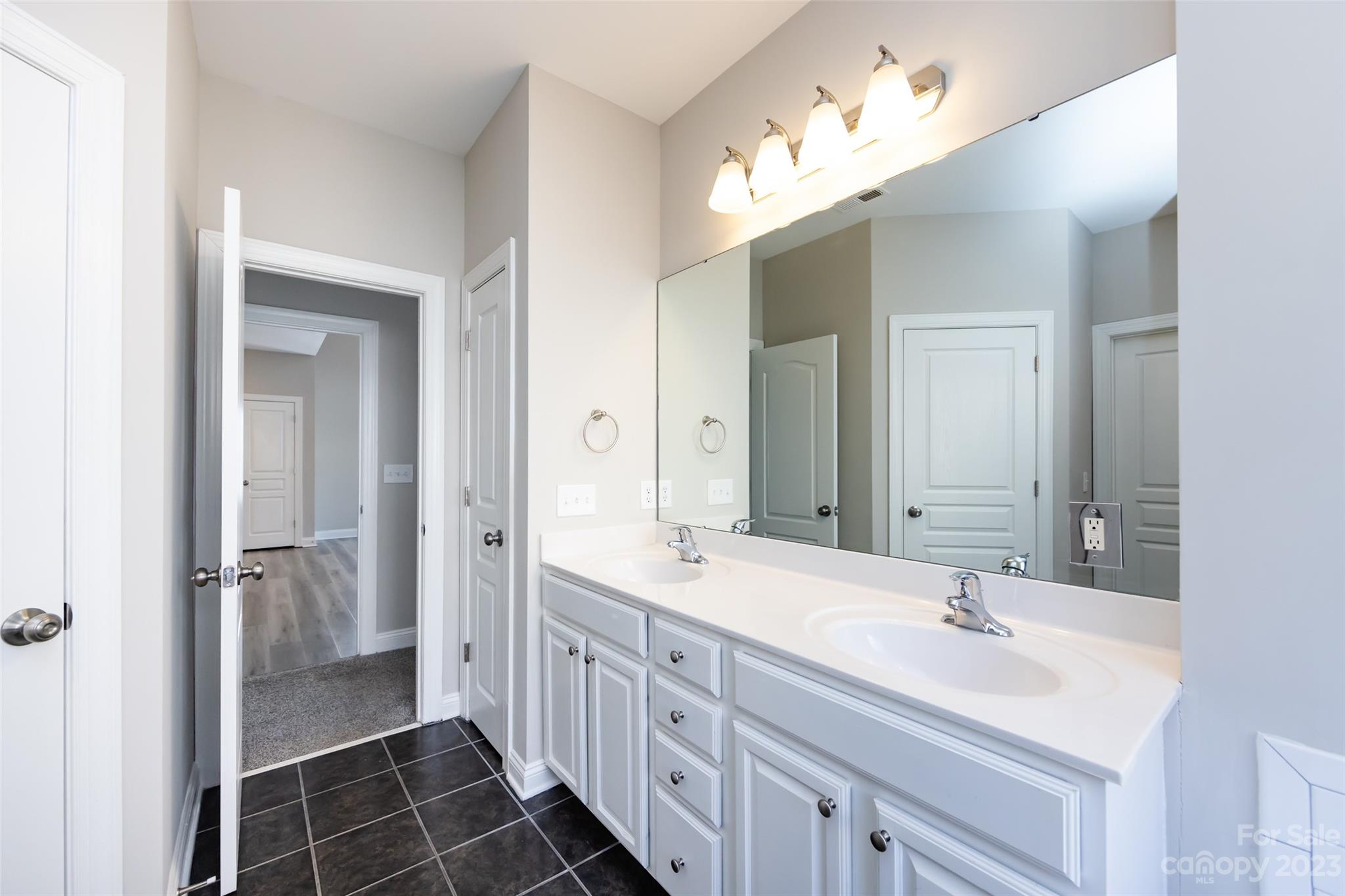 18909 Ruffner Drive Cornelius, NC 28031 - Photo 13 of 22 a bathroom with a double vanity sink mirror and double