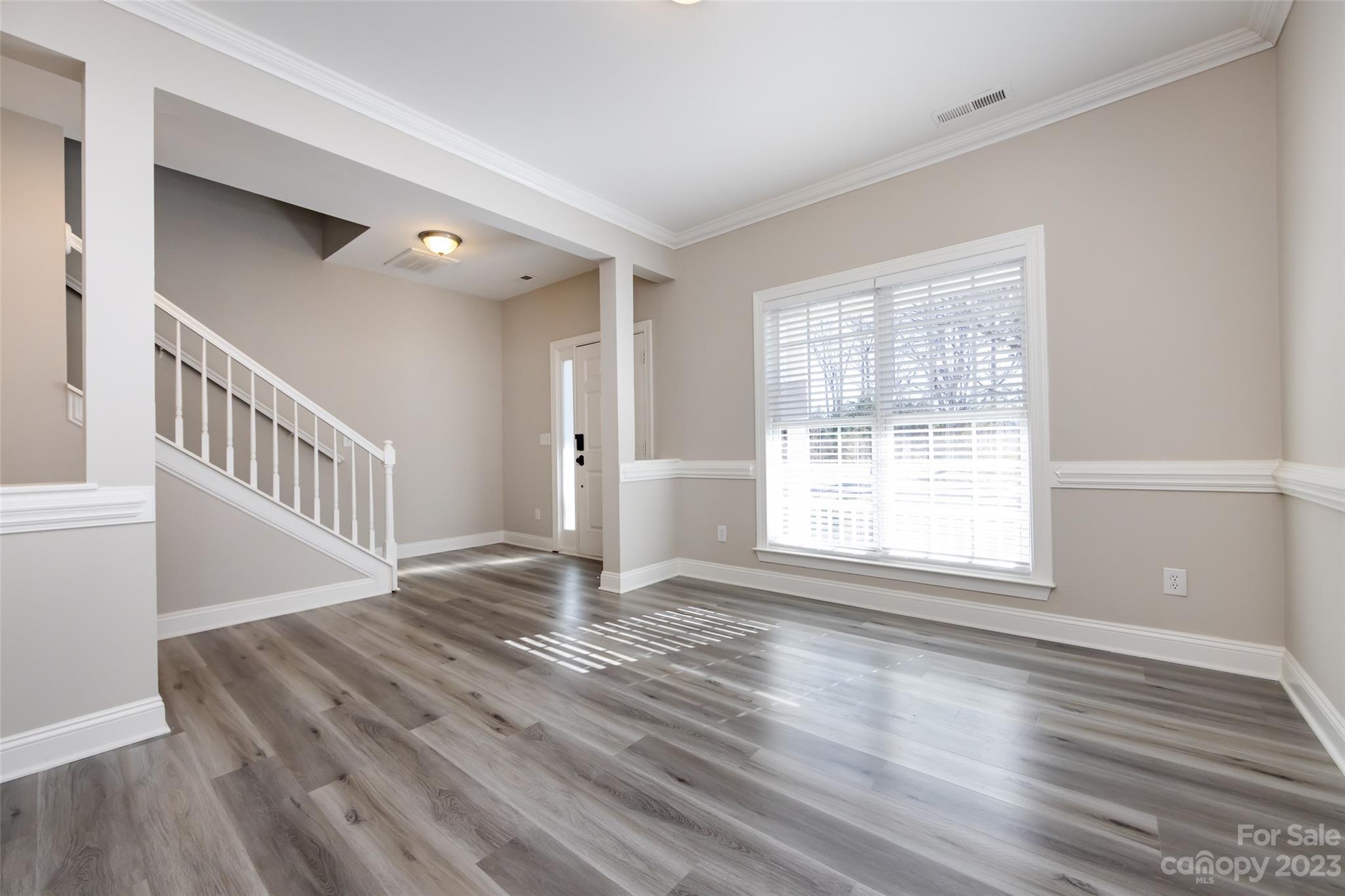18909 Ruffner Drive Cornelius, NC 28031 - Photo 3 of 22 a view of an empty room with wooden floor and a window