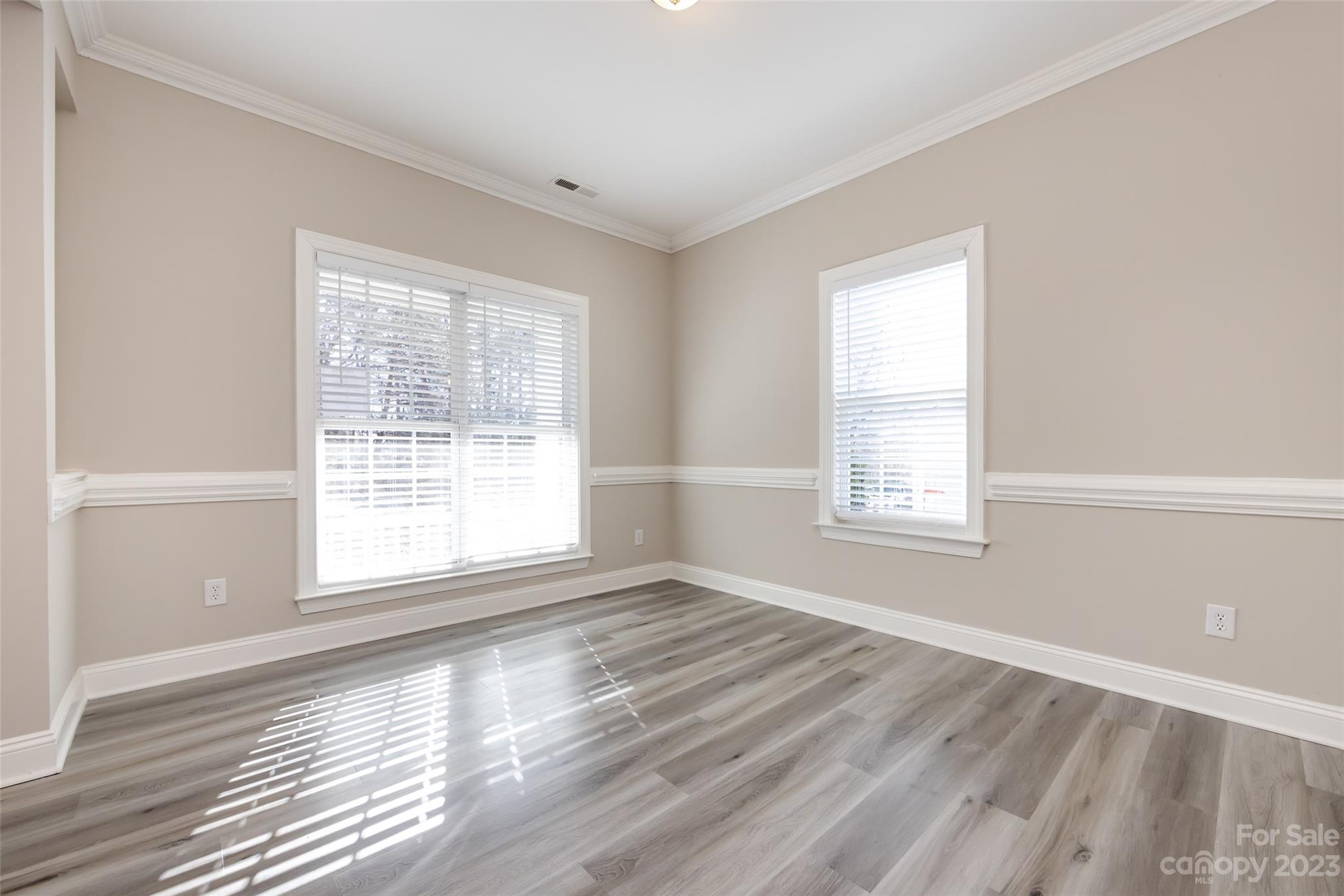 18909 Ruffner Drive Cornelius, NC 28031 - Photo 4 of 22 an empty room with wooden floor and windows