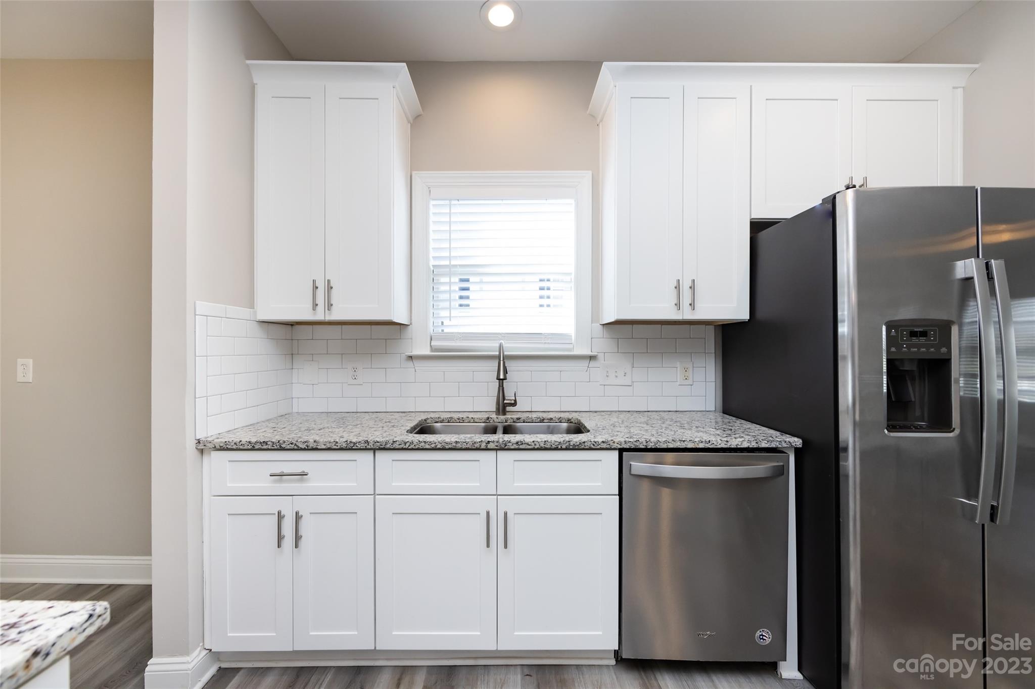 18909 Ruffner Drive Cornelius, NC 28031 - Photo 6 of 22 a kitchen with stainless steel appliances granite countertop a refrigerator sink and cabinets