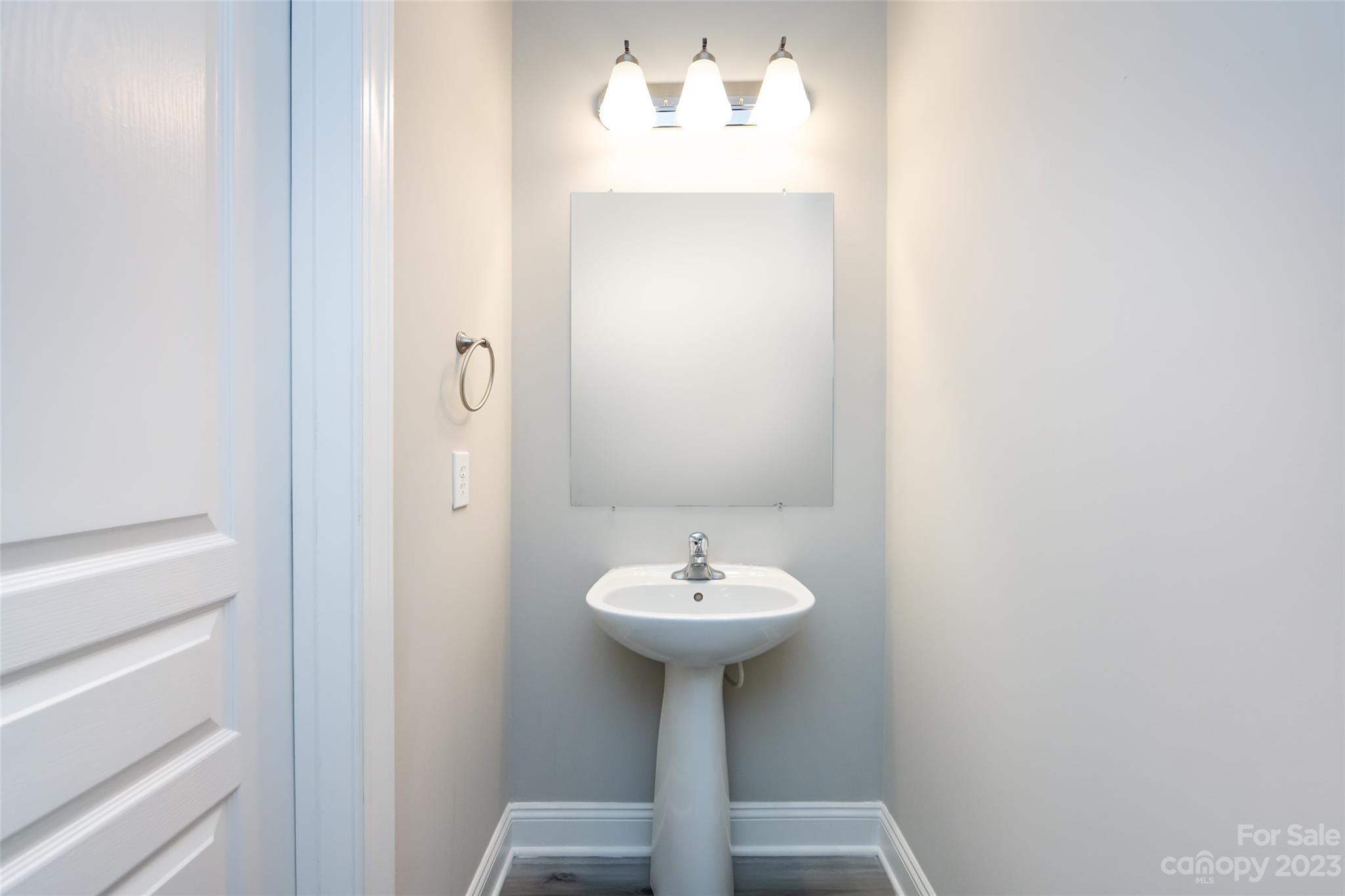 18909 Ruffner Drive Cornelius, NC 28031 - Photo 9 of 22 a bathroom with a sink a mirror and a toilet