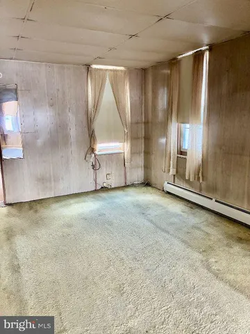 a view of an empty room with a fireplace