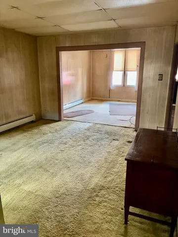 a view of a room with wooden walls and window