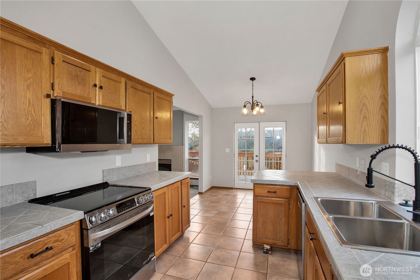 5607 Vincent Court Southeast Lacey, WA 98513 - Photo 12 of 40 a kitchen with stainless steel appliances granite countertop a sink and a stove