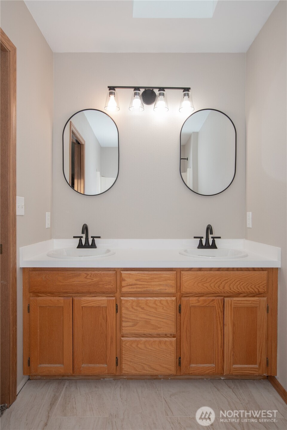 5607 Vincent Court Southeast Lacey, WA 98513 - Photo 15 of 40 a bathroom with a double vanity sink and a mirror