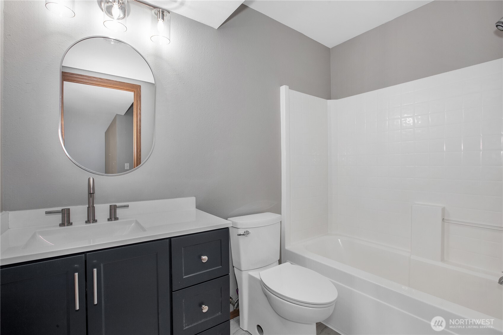 5607 Vincent Court Southeast Lacey, WA 98513 - Photo 27 of 40 a bathroom with a toilet a sink a mirror a bathtub and vanity