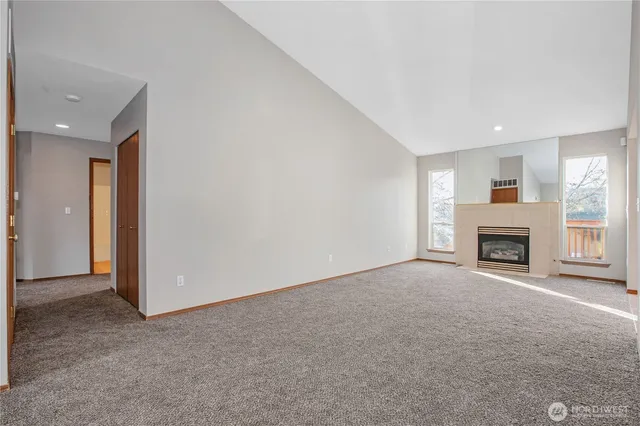 a view of a livingroom with a fireplace and a window
