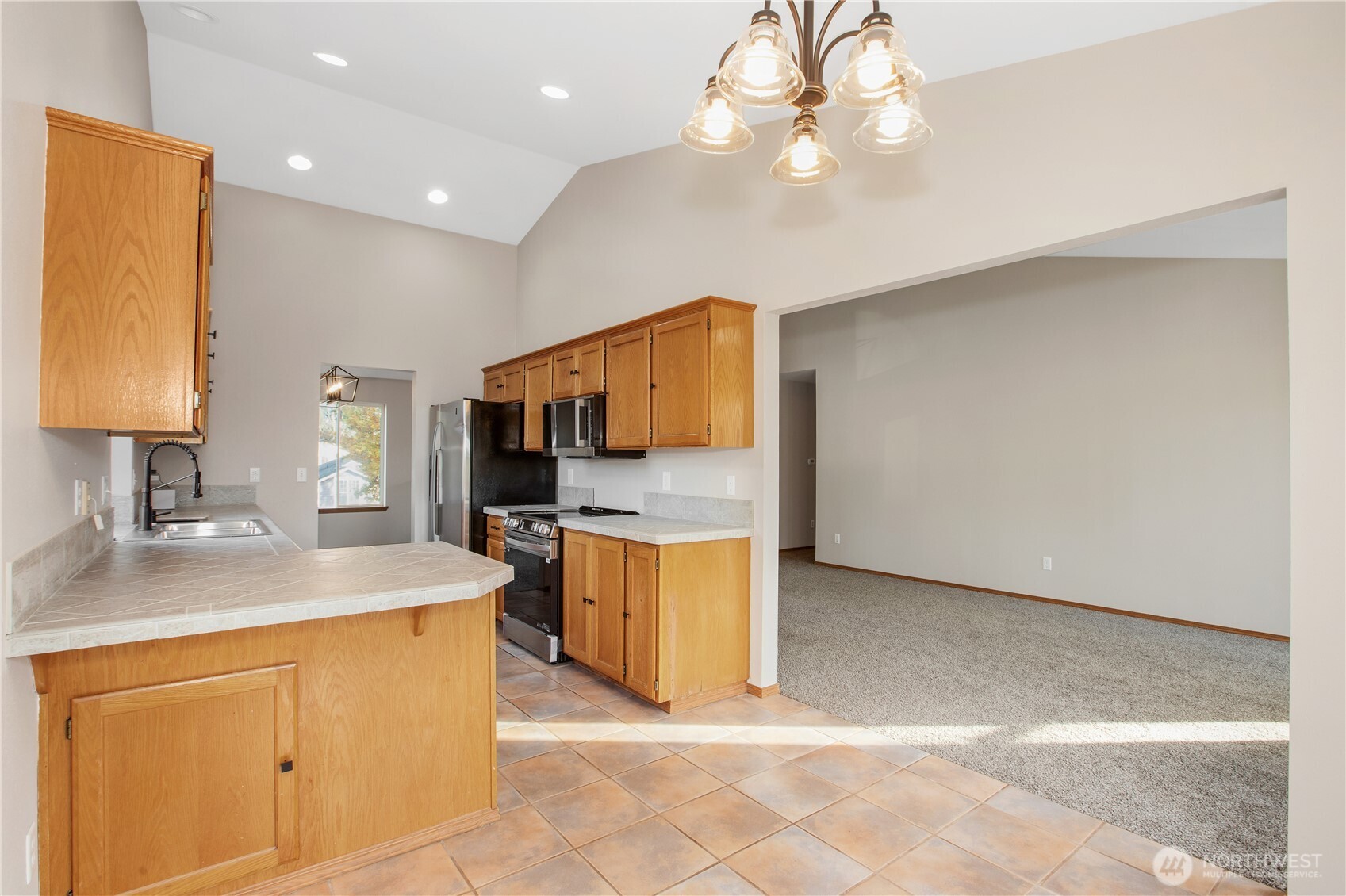 5607 Vincent Court Southeast Lacey, WA 98513 - Photo 8 of 40 a kitchen with a sink and a refrigerator