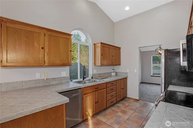 a spacious bathroom with a granite countertop sink and a mirror