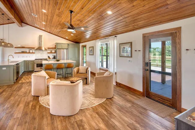 a living room with furniture and a chandelier