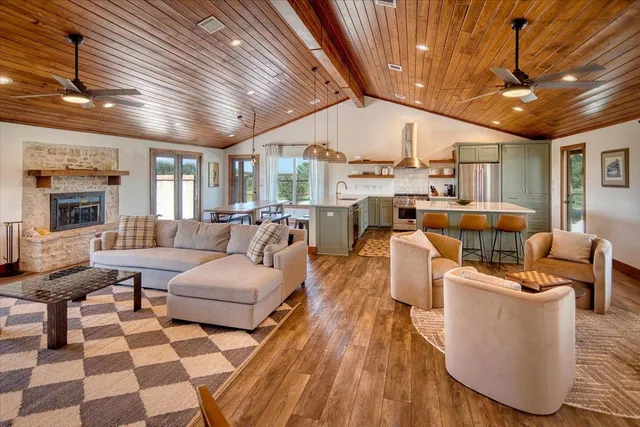 a living room with lots of furniture and a large window