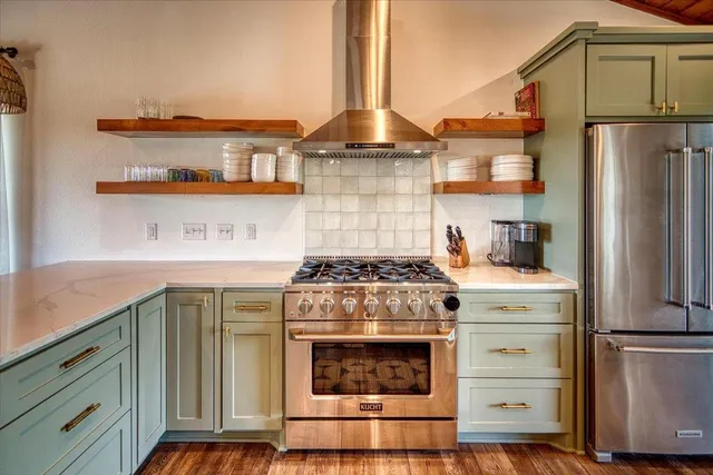 a stove top oven sitting inside of a kitchen