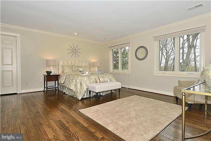 1291 Berry Place McLean, VA 22102 - Photo 14 of 30 a spacious bedroom with a bed a table and chair