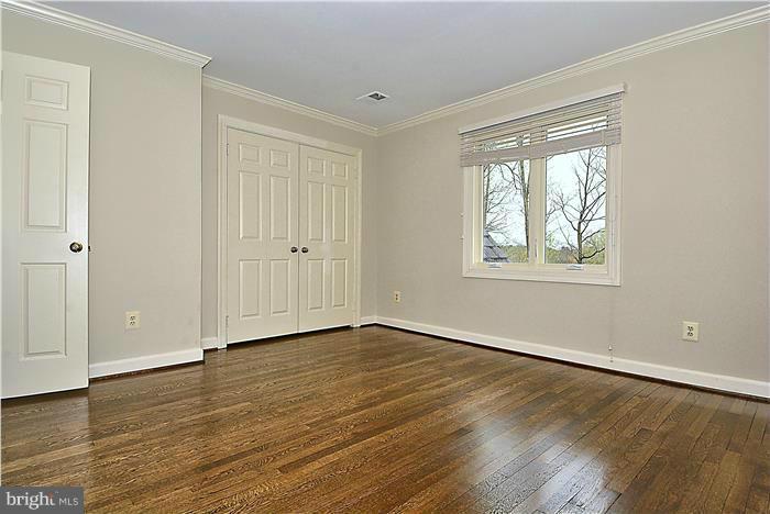 1291 Berry Place McLean, VA 22102 - Photo 22 of 30 a view of an empty room with wooden floor and a window