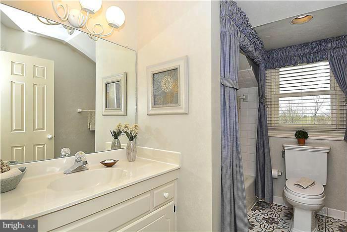 1291 Berry Place McLean, VA 22102 - Photo 23 of 30 a bathroom with a sink a toilet and shower