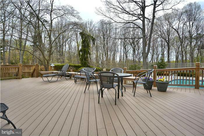 1291 Berry Place McLean, VA 22102 - Photo 27 of 30 a view of a roof deck with table and chairs wooden floor and fence