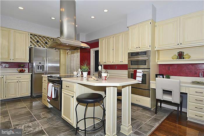 1291 Berry Place McLean, VA 22102 - Photo 5 of 30 a kitchen with stainless steel appliances kitchen island granite countertop a sink and cabinets