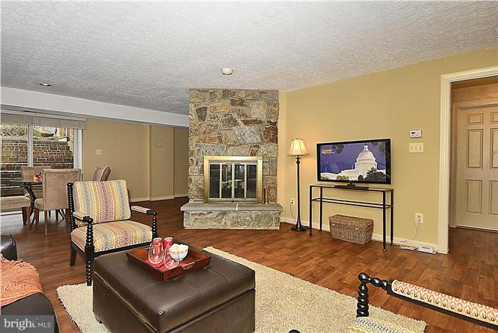 1291 Berry Place McLean, VA 22102 - Photo 7 of 30 a living room with furniture and a flat screen tv