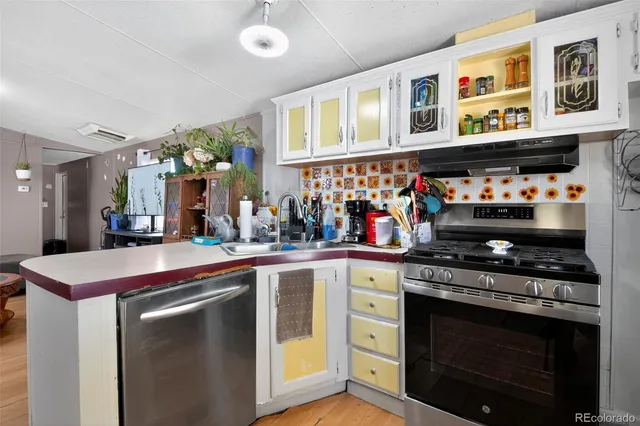 a kitchen with stainless steel appliances granite countertop a stove and cabinets