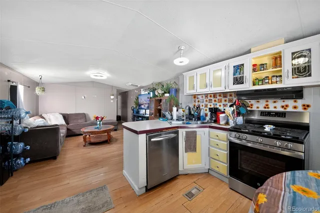 a kitchen with stainless steel appliances granite countertop a stove and a refrigerator