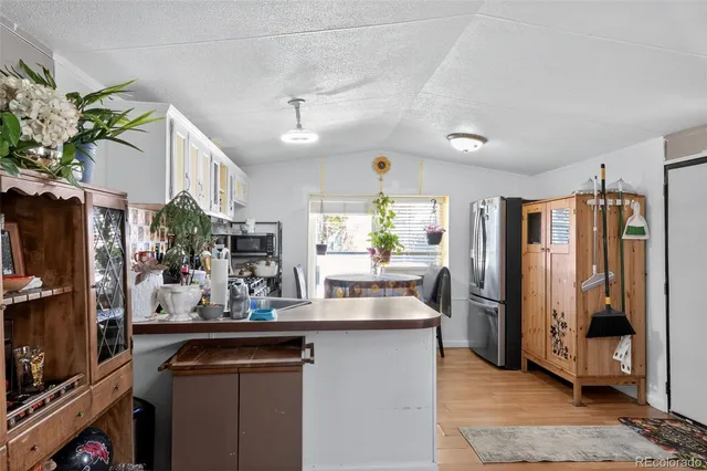 a kitchen with stainless steel appliances granite countertop a refrigerator and a sink