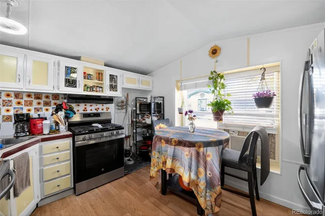 a open kitchen with stainless steel appliances granite countertop a stove and a refrigerator