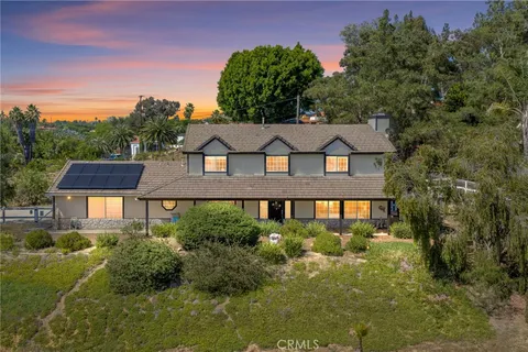 a view of a house with a yard and garden