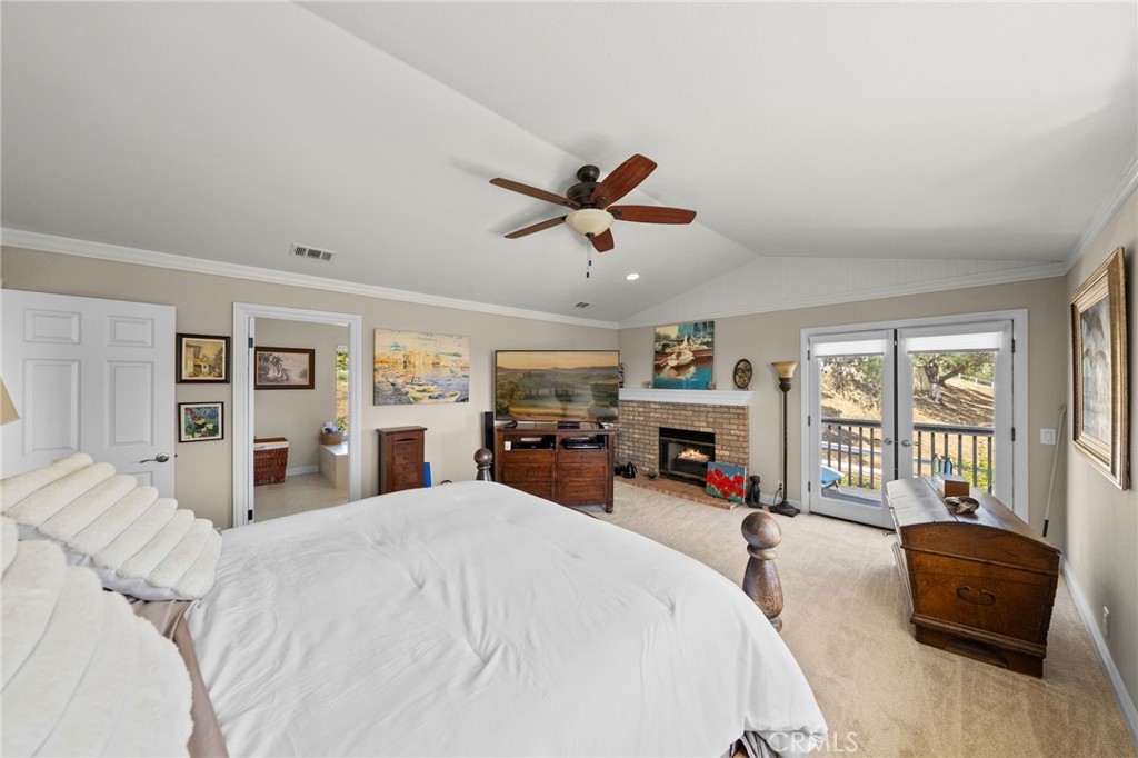 3162 Reche Road Fallbrook, CA 92028 - Photo 17 of 33 a bed room with a bed and a fireplace