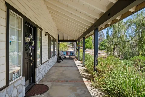 a view of balcony with wooden floor and fence