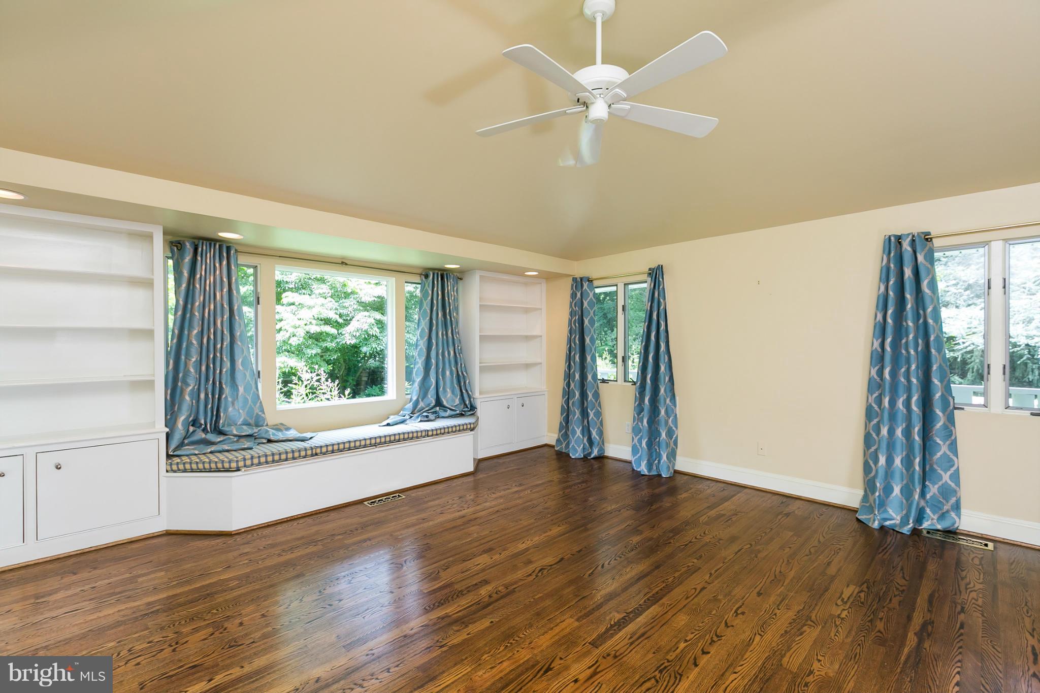 1732 Ruxton Road Baltimore, MD 21204 - Photo 22 of 30 an empty room with wooden floor fan and windows