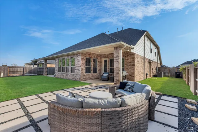 a view of a house with backyard porch and sitting area