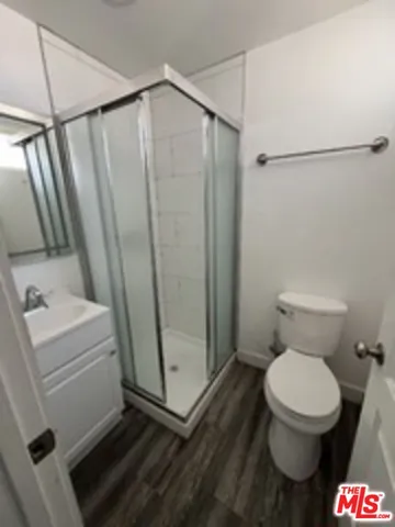 a bathroom with a toilet and a shower