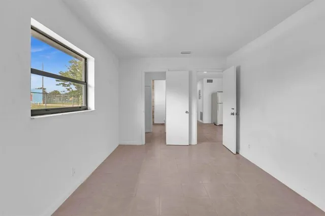 a view of an empty room with a cabinet