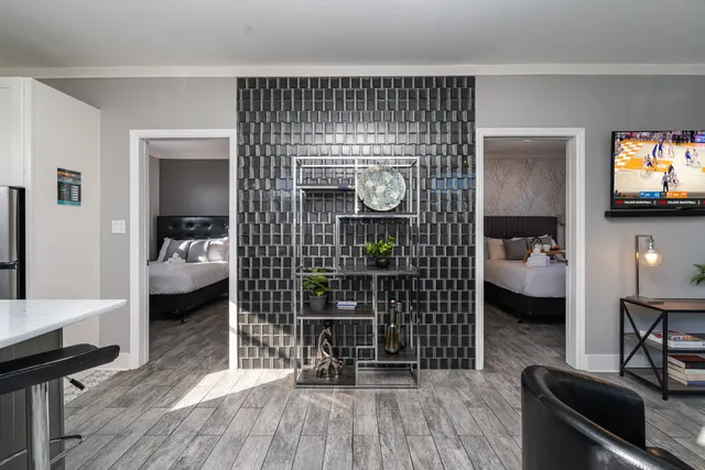 a bedroom with furniture and a wooden floor