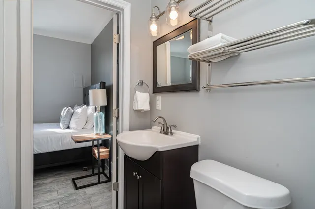 a bathroom with a toilet a sink and a mirror