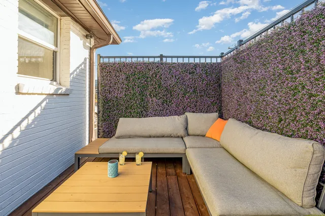 a view of a balcony with furniture