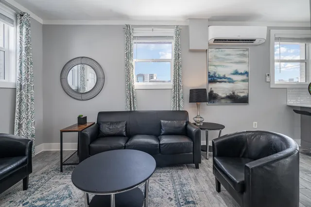 a living room with furniture and a mirror