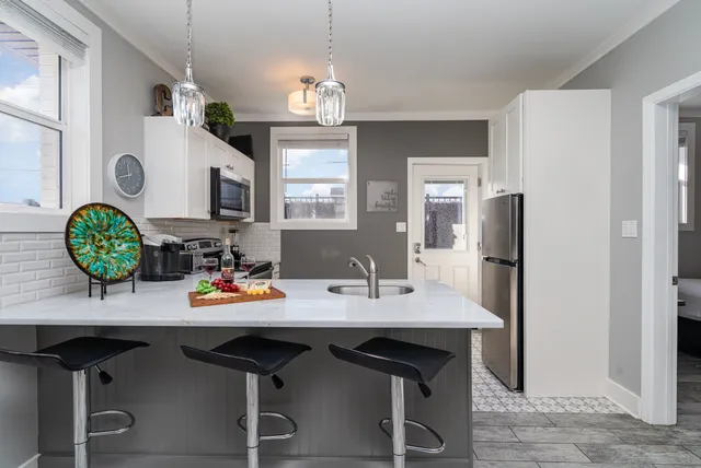 a view of a dining room with furniture and chandelier