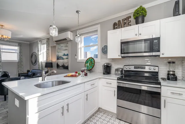 a kitchen with a sink stove and microwave
