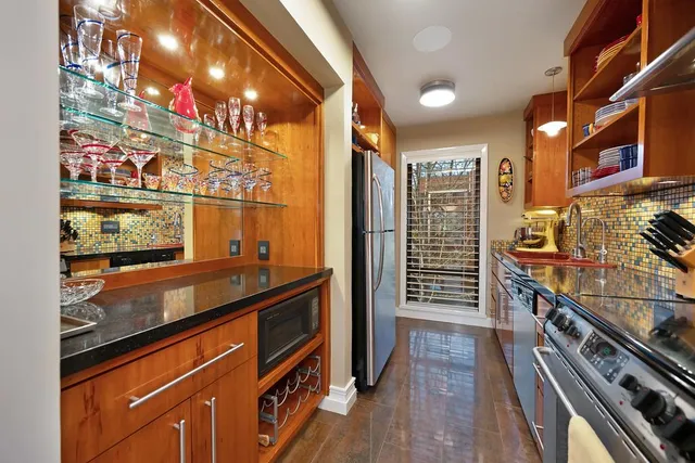 a bathroom with a granite countertop sink mirror and a bath tub