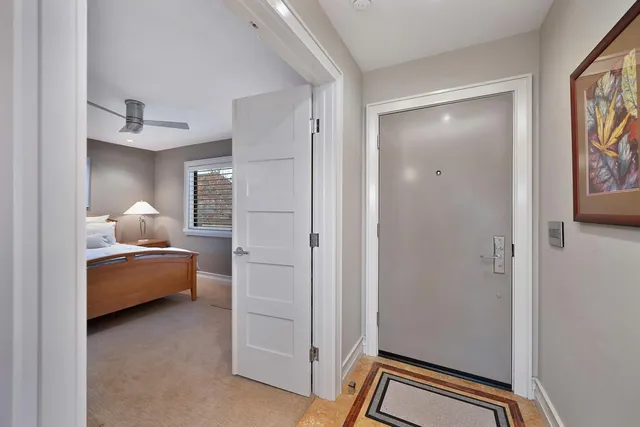 a bedroom with a bed and a painting on the wall