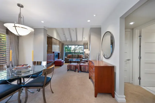 a living room with fireplace furniture and a chandelier